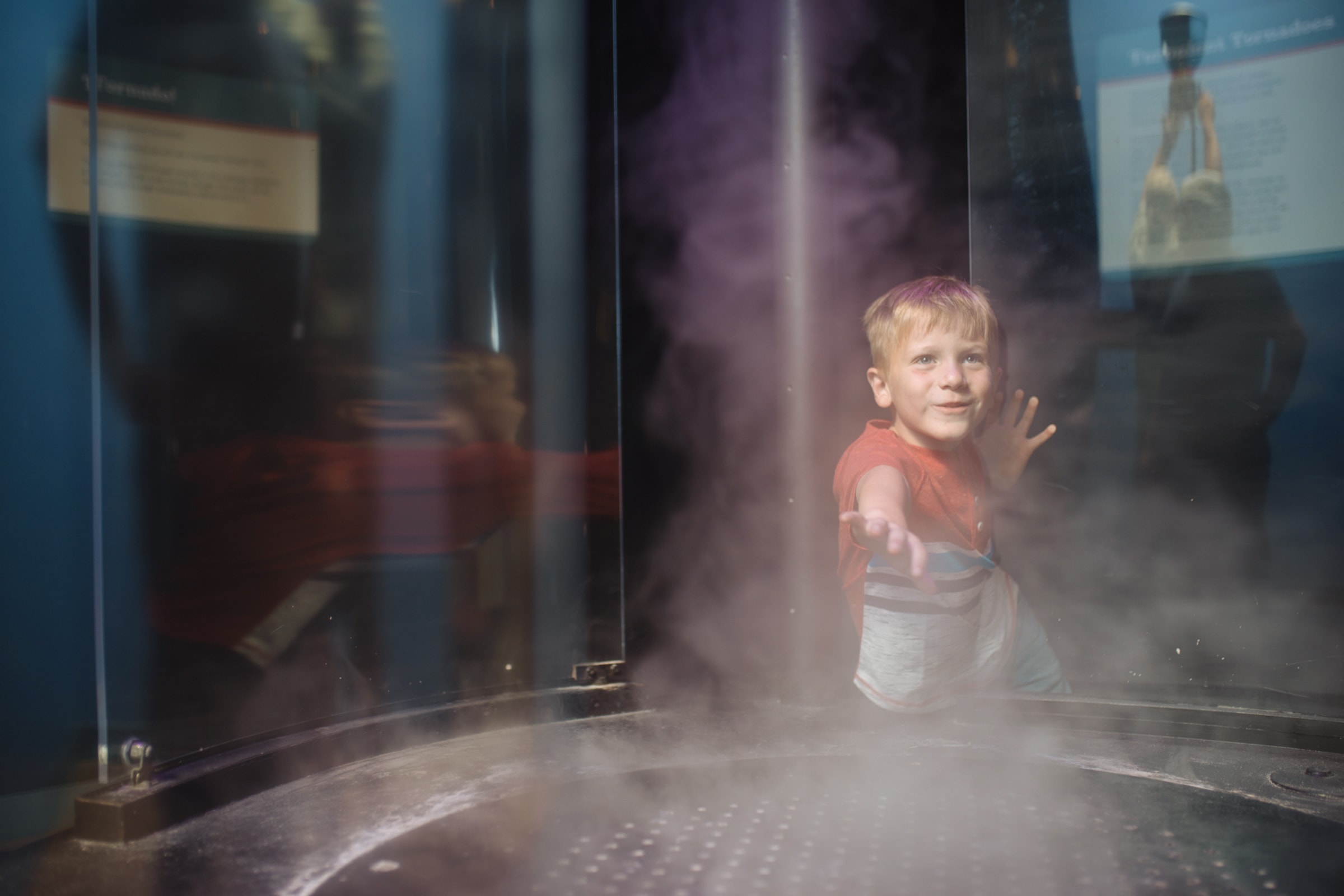 Boy playing in mist at Ecology & Environments.