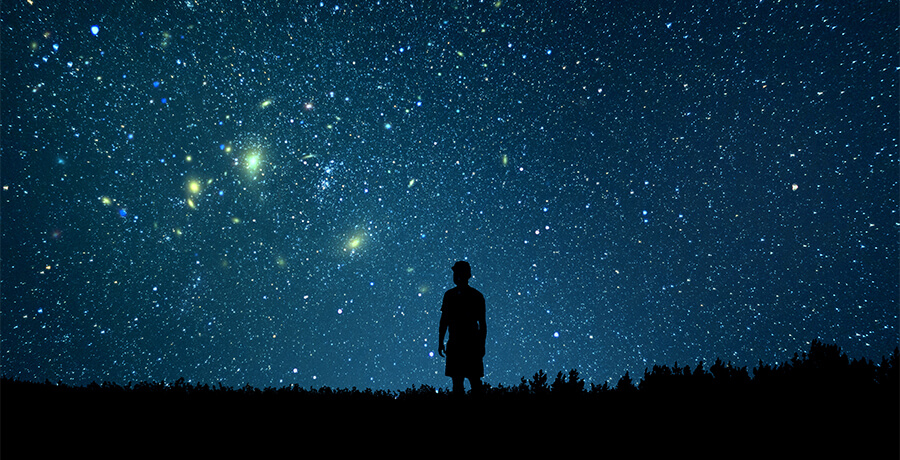Man looking at the stars. Alone man looking at starry sky. Night sky.