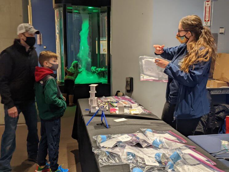 The Science Center team hands out STEAM kits to guests at the Community STEAM Showcase.